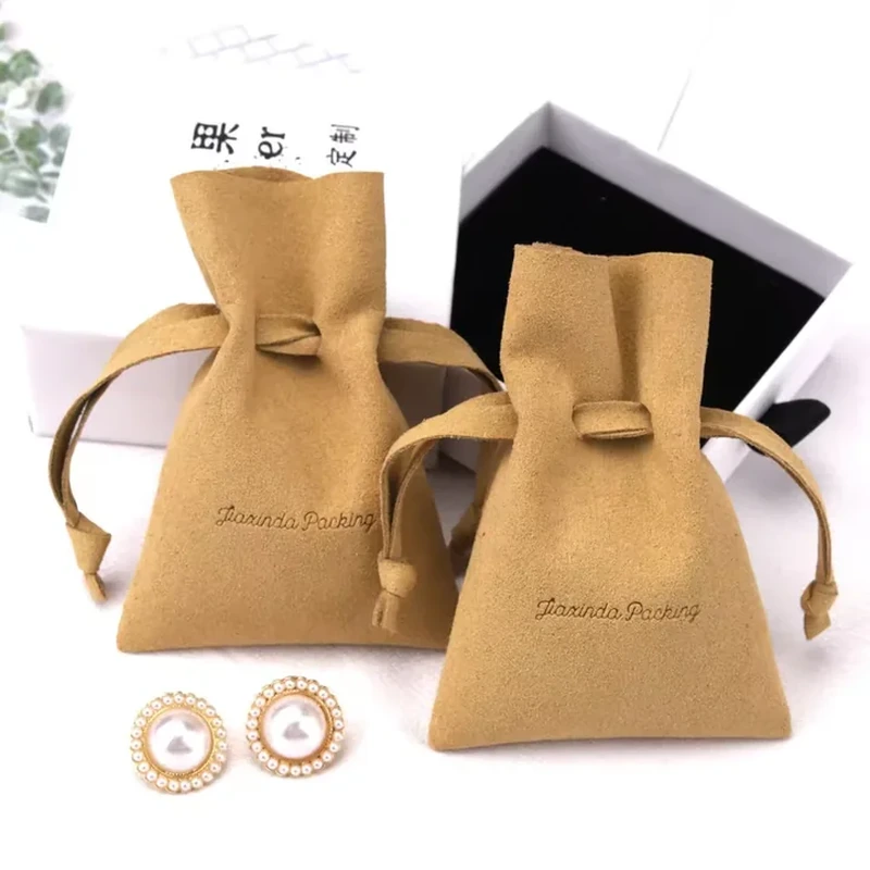 A short horizontal tab draws in the neck of this flared jewelry pouch