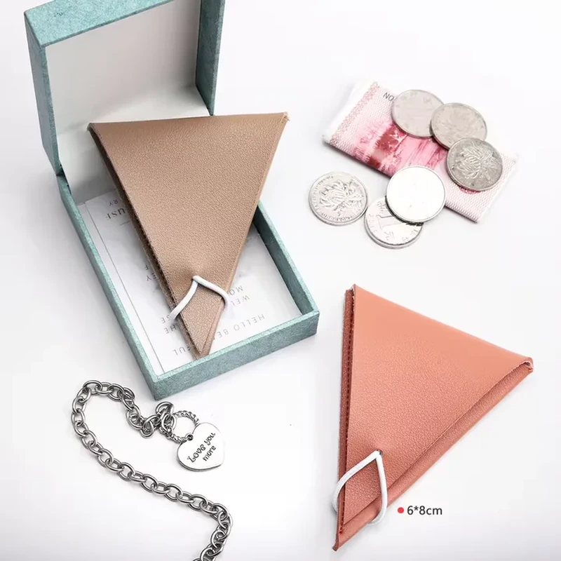 Triangular leather-look accessory pouches with visible edge stitching and loop details
