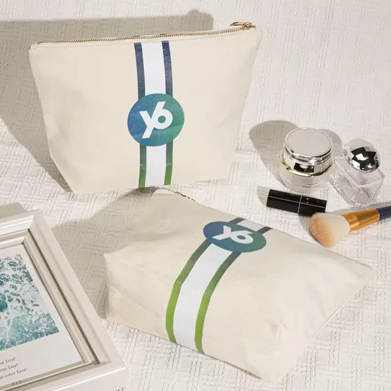 A pale zip pouch has two printed vertical stripes and a circular graphic centered between them