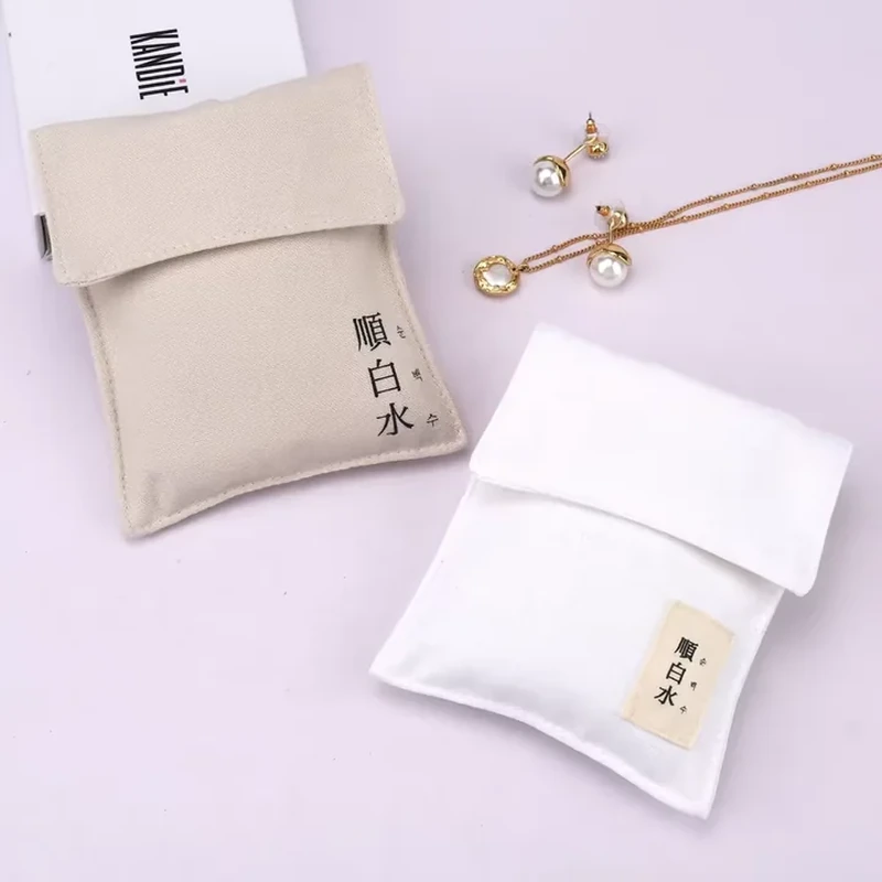 A slim vertical sleeve uses a broad folded flap and a small print near its lower corner
