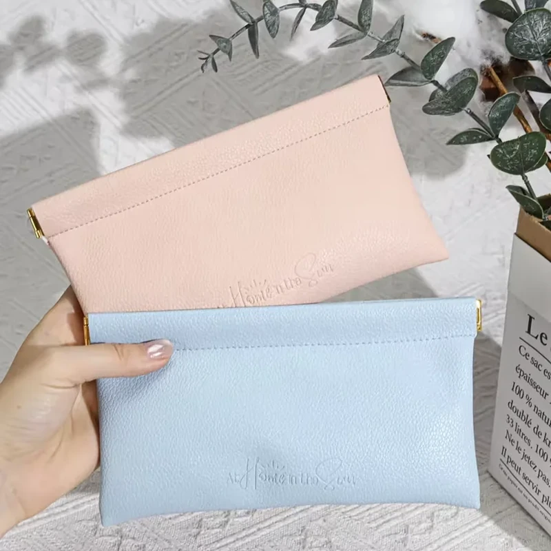 Wide pastel leather-look pouches with straight flex-style openings and textured surfaces