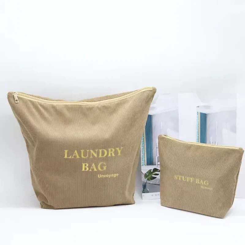A broad zippered pouch has a tapered body and a coordinated smaller companion