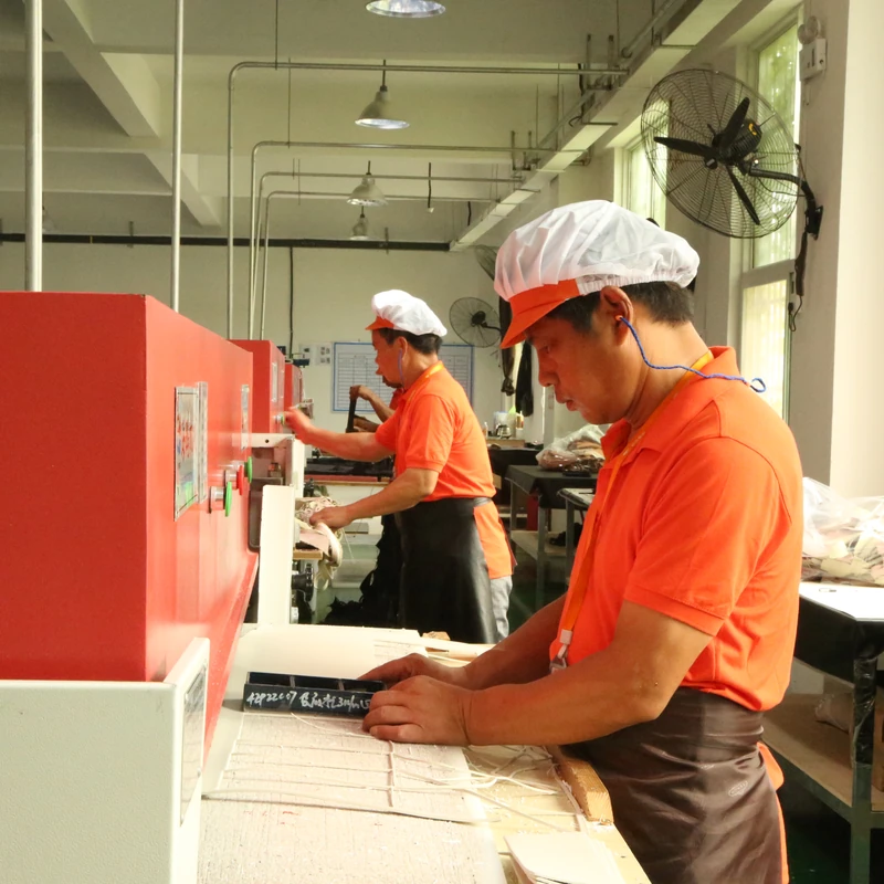 Operators handling bag components at material preparation workstations.