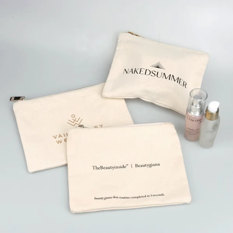Cream zipper pouches in three sizes beside cosmetic items