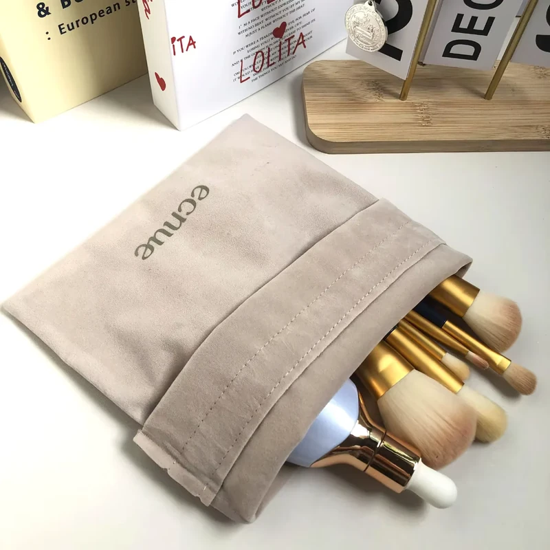 Open fabric pouch holding makeup brushes