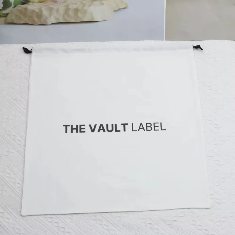 Flat white drawstring pouch with a black printed wordmark.