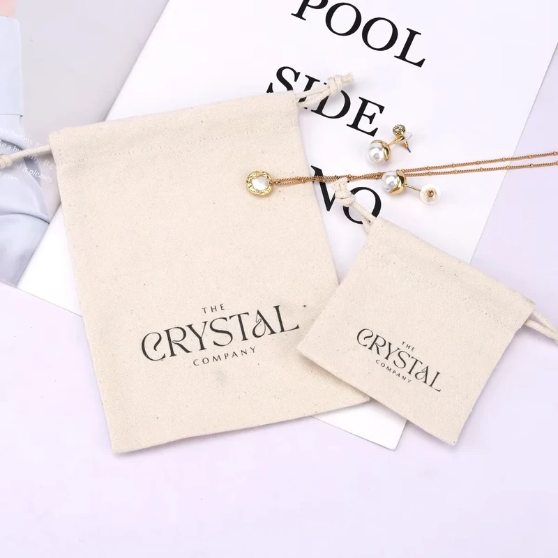Two cream pouches with matching printed wordmarks