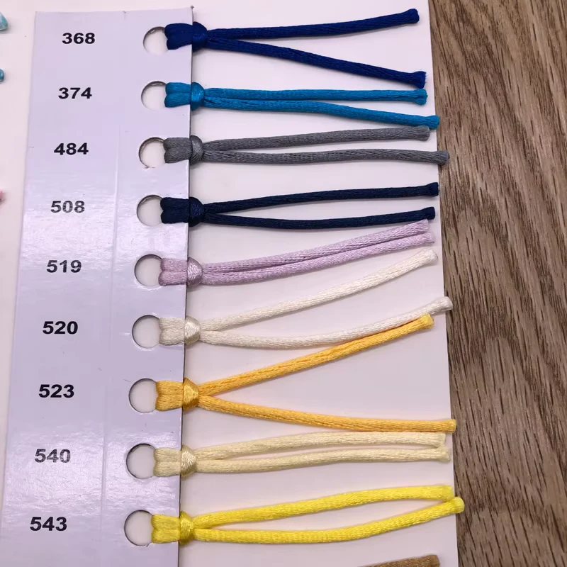 Color samples of short knotted drawcords mounted on a card