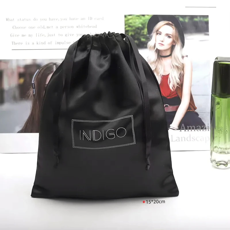 Black drawstring pouch standing with its top gathered