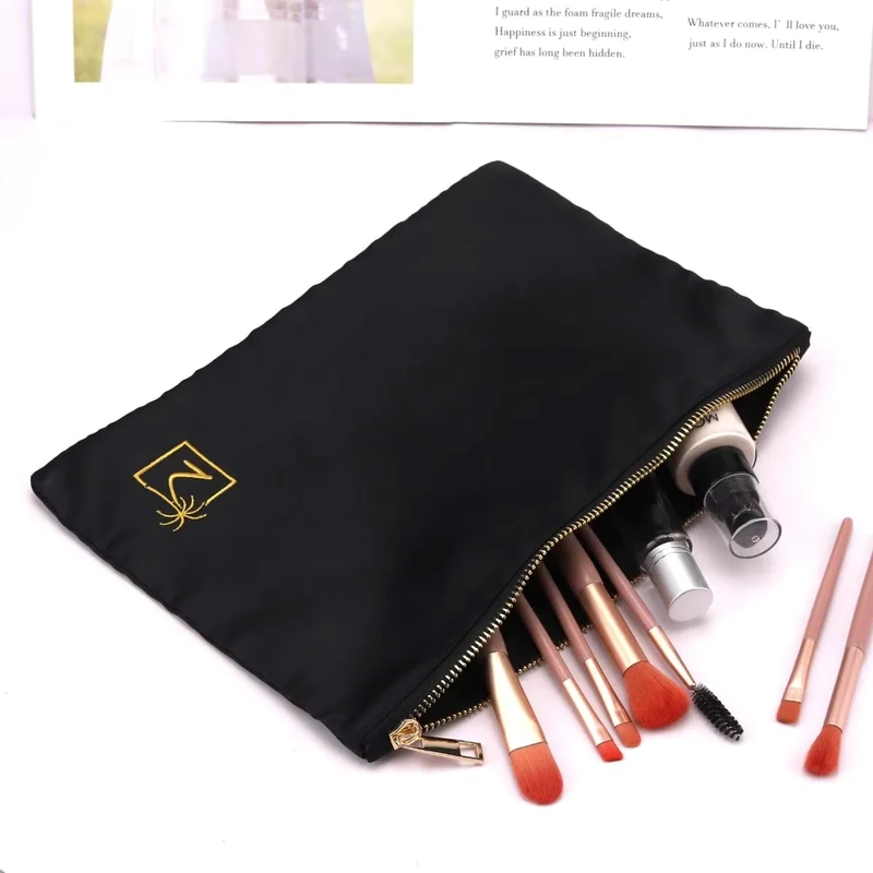 Open black zipper pouch holding makeup brushes