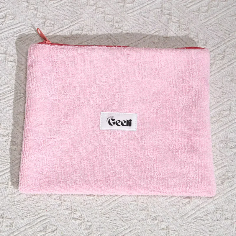 Pink loop-textured zipper pouch with a sewn front label