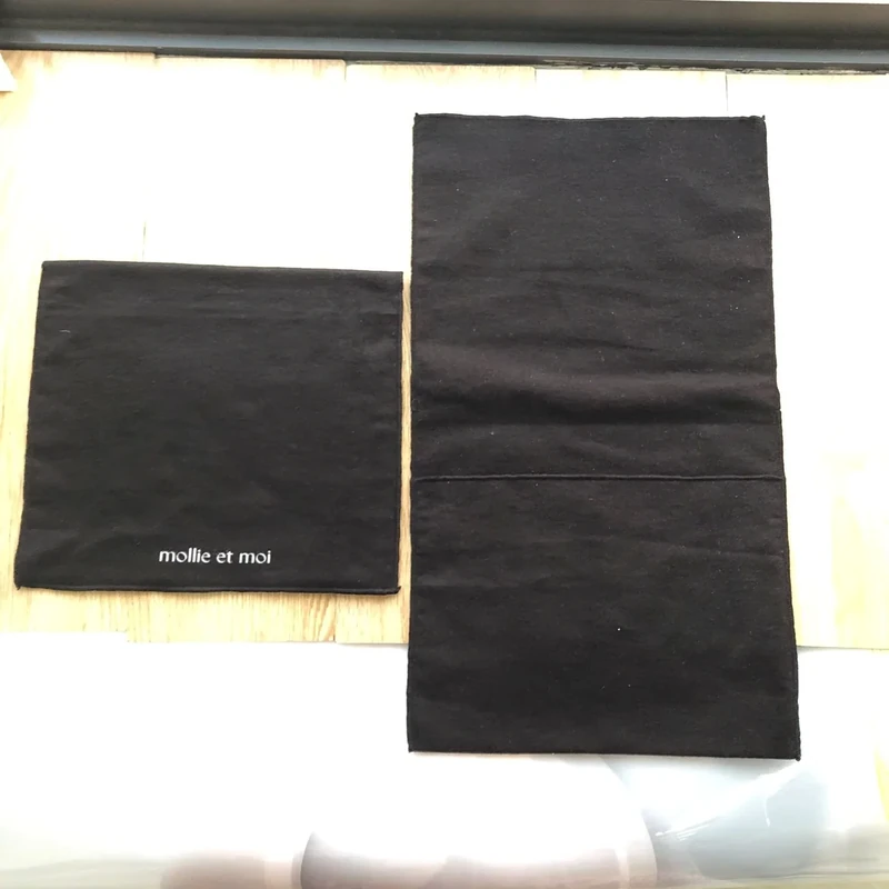 Two dark flat fabric pouches in different proportions