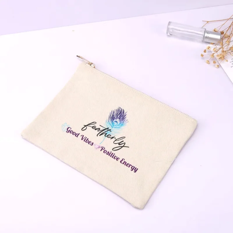 Cream zipper pouch with a colorful feather illustration and printed lettering.