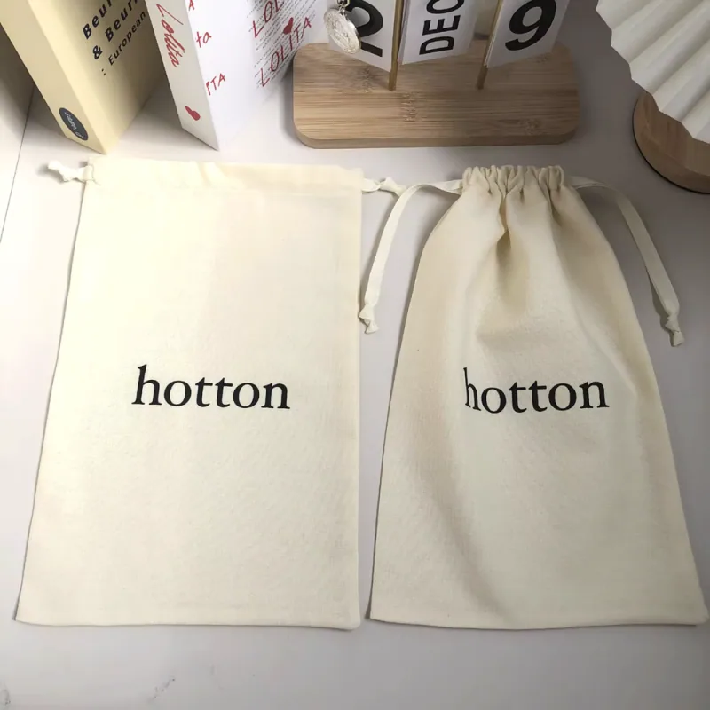 Two cream fabric pouches shown flat and gathered at the drawstring opening.