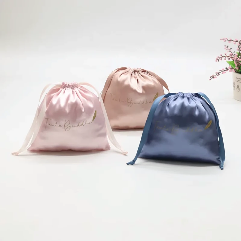 Three lustrous drawstring pouches in pink, champagne and blue