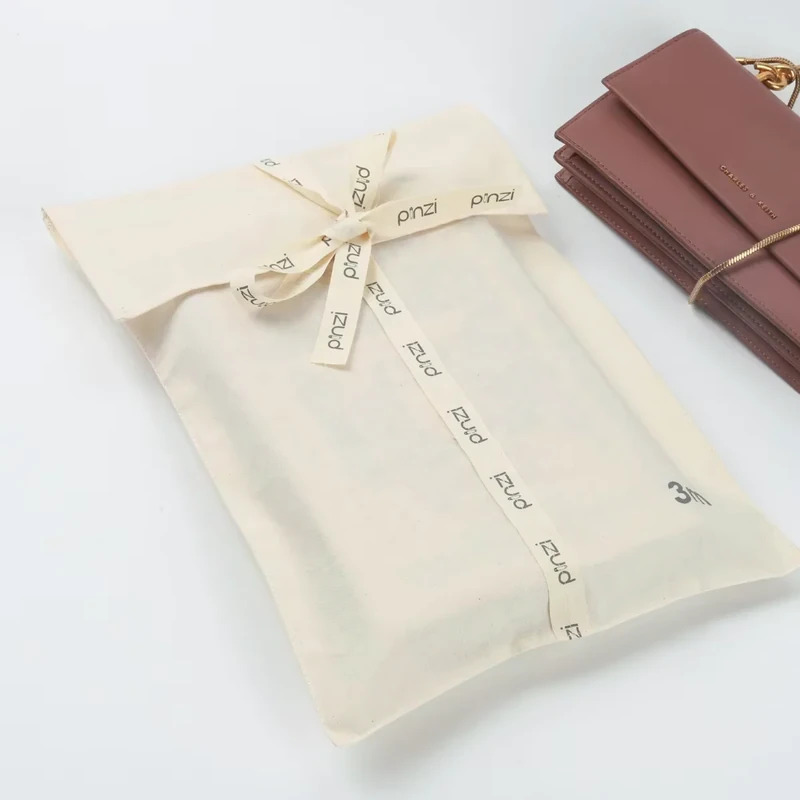 White fabric gift envelope with a tied narrow ribbon