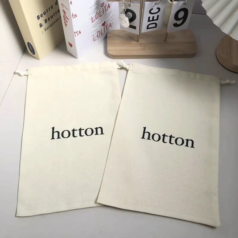 Two long cream fabric sleeves laid flat