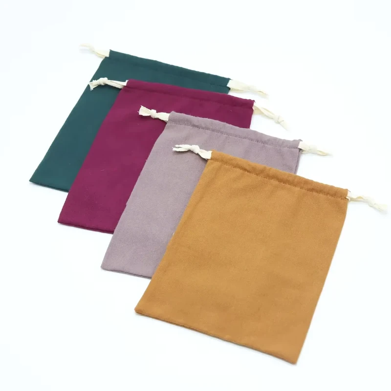 Flat fabric pouches in gray, green, purple and ochre