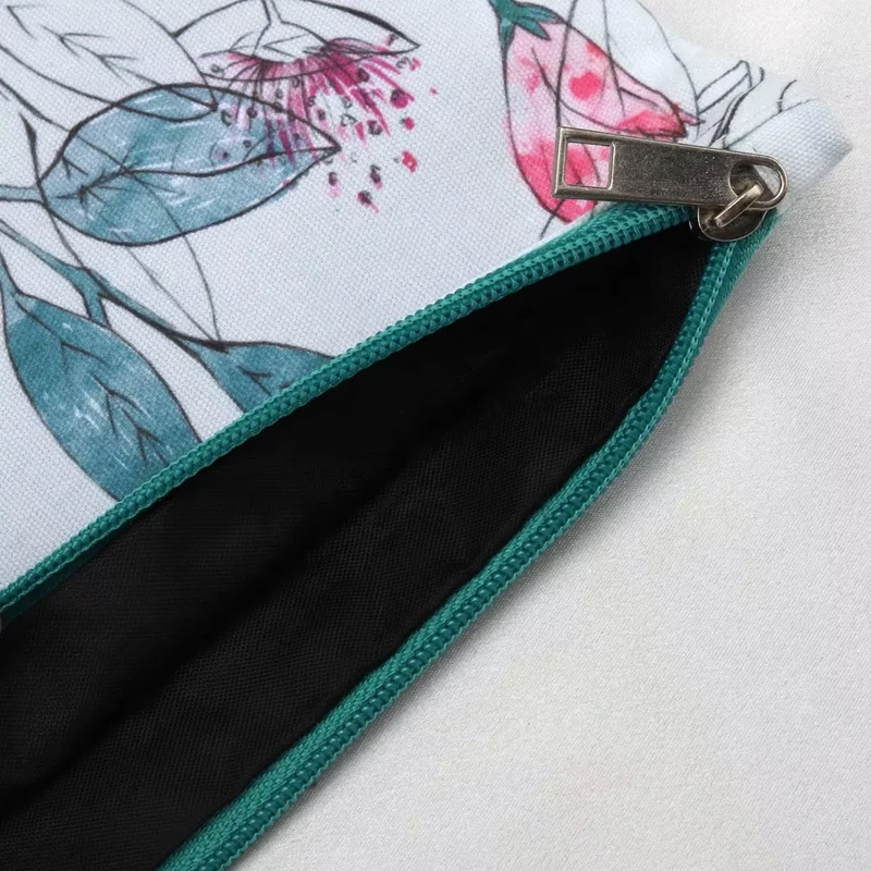 Open floral pouch showing its dark lining and teal zipper binding