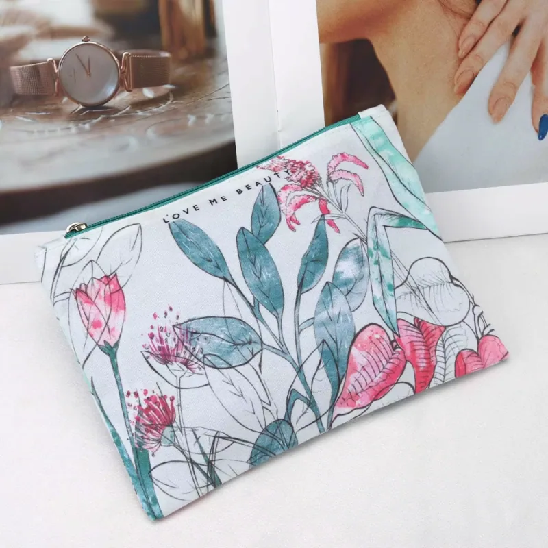 Floral gusseted cosmetic pouch with a teal zipper