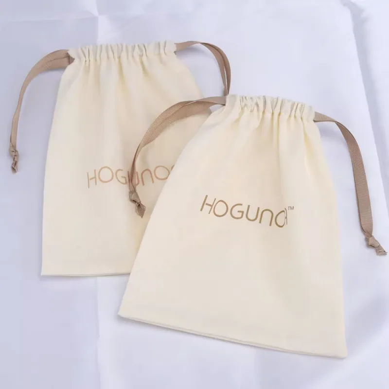 Two ivory cotton drawstring bags with beige ribbon ties