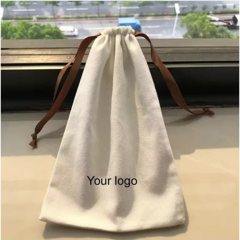 Natural cotton drawstring bag with brown ribbon ties and a printed logo
