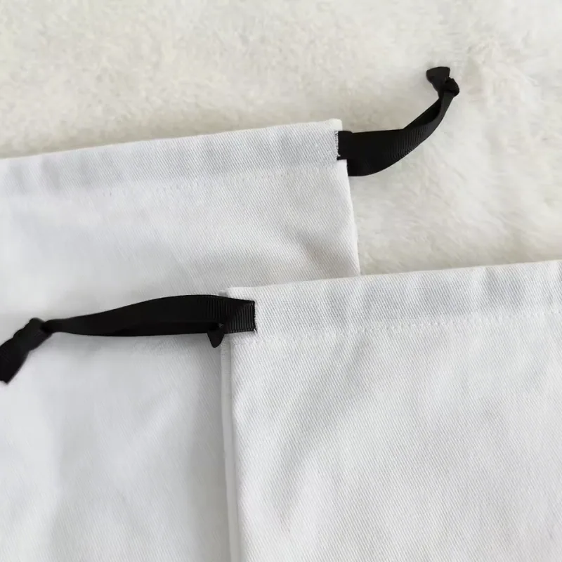 Close-up of the cotton fabric and black ribbon channel on a drawstring bag