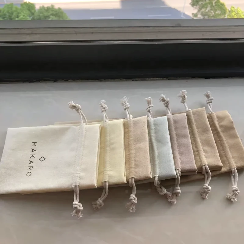 Finished cotton drawstring bags grouped in muted fabric colors.