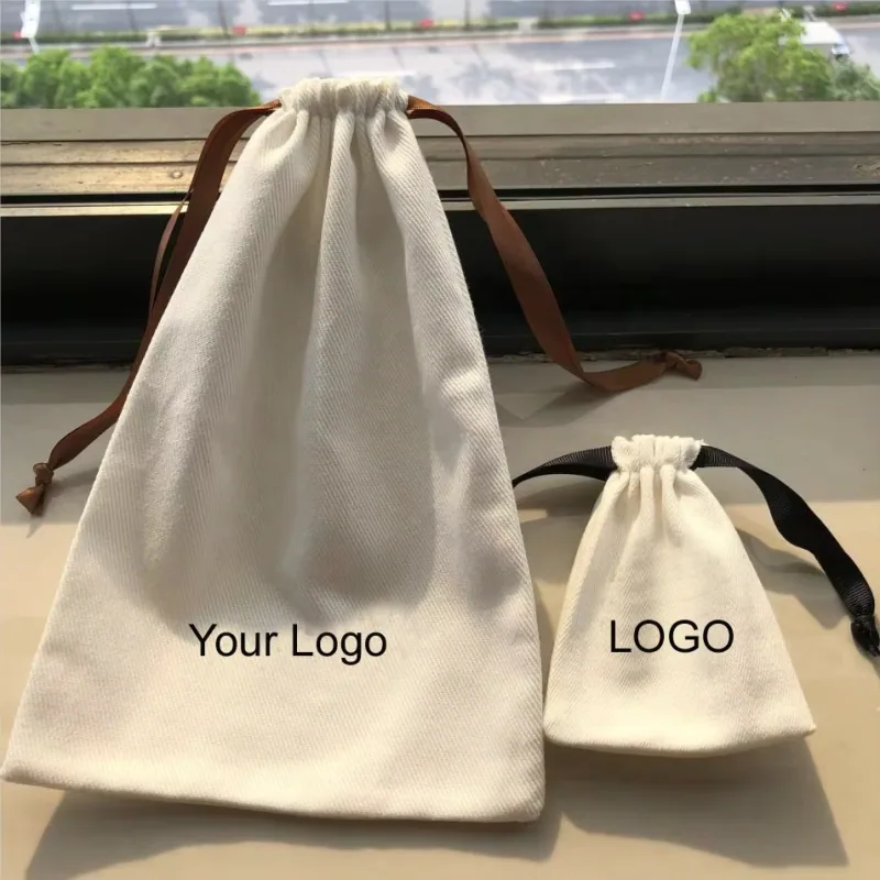 Two natural cotton drawstring bags in different sizes with contrasting ribbon ties