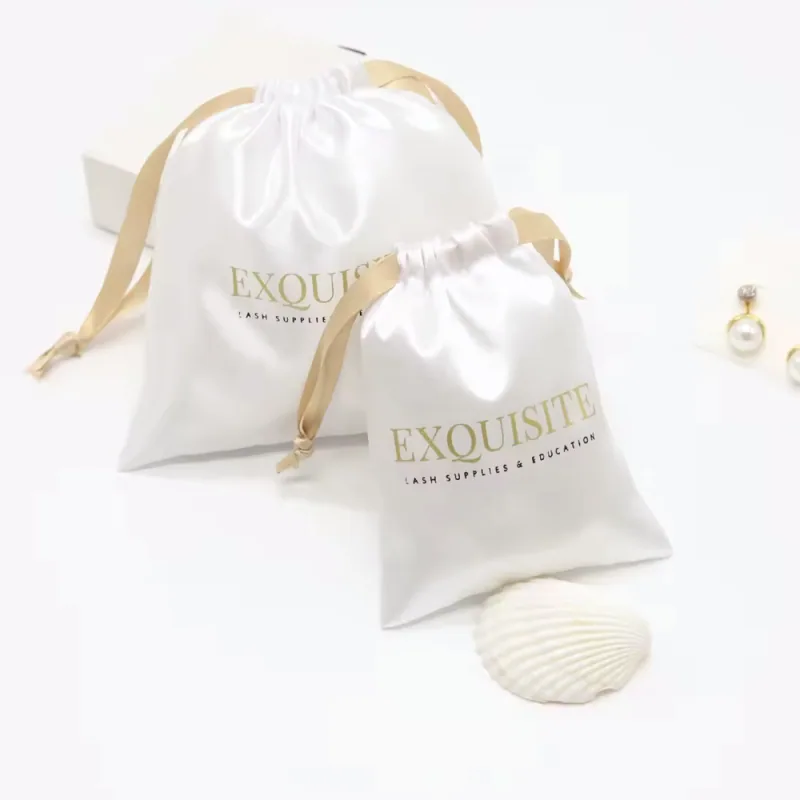 Ivory satin gift pouches with gold ribbon ties