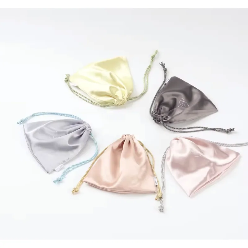 Satin drawstring jewelry pouches in assorted pastel colors