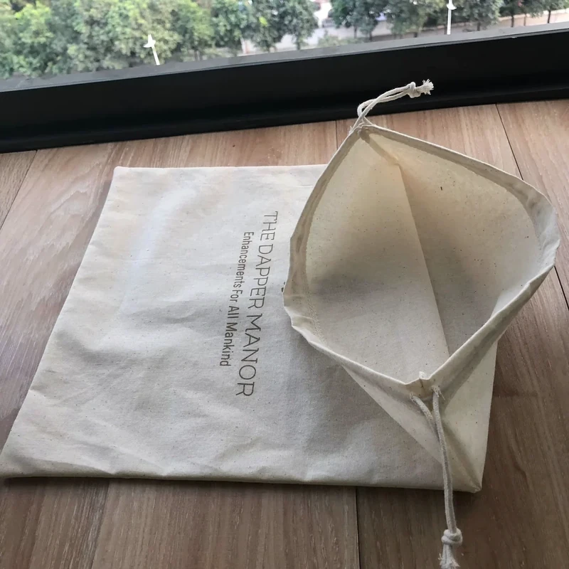 Open natural cotton bag showing its inside seam and drawstring channel