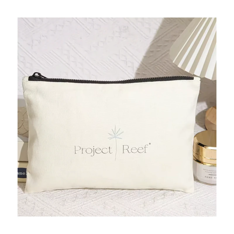 Ivory woven cotton zip pouch with a black zipper and pale printed logo