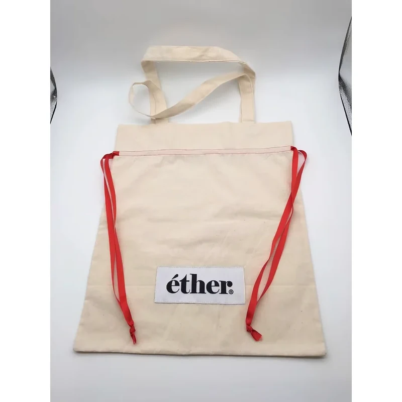 Natural cotton bag with long carry handles and red drawstring cords