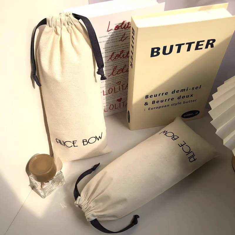 Cotton drawstring bag samples shown standing and lying flat as a set.