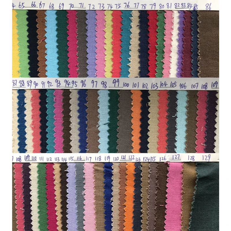 Woven fabric color swatches with pinked edges and handwritten reference numbers