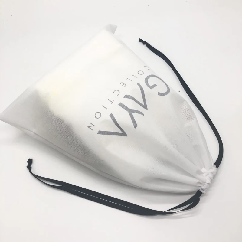 White printed drawstring pouch laid diagonally with black ribbon ties