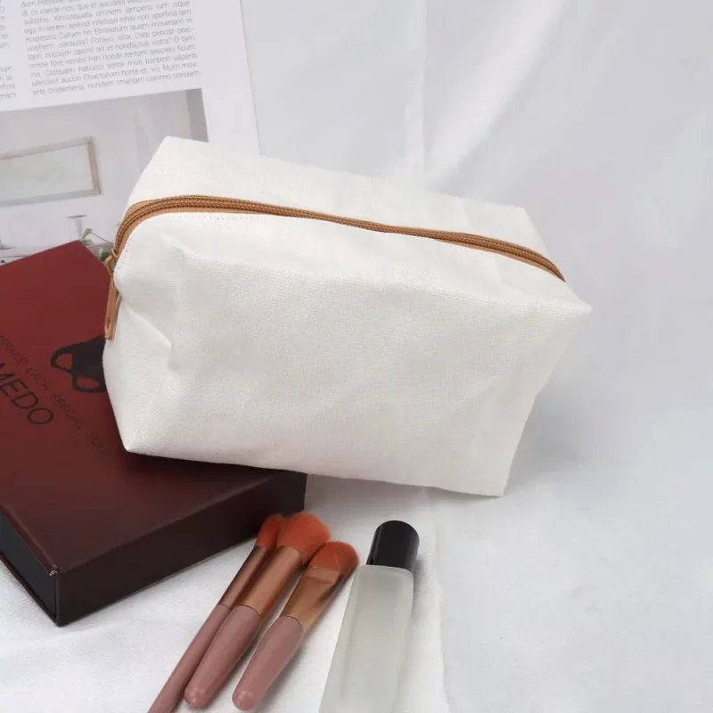 Cream canvas gusseted travel pouch with a tan zipper and pull tabs