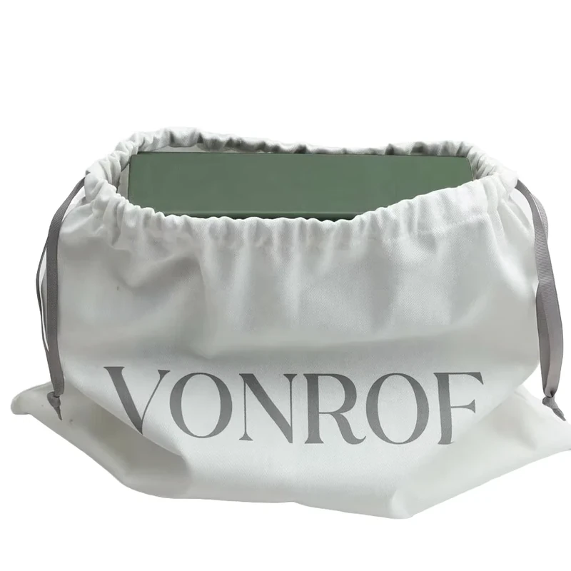 A gray travel pouch with its drawstring opening spread wide.