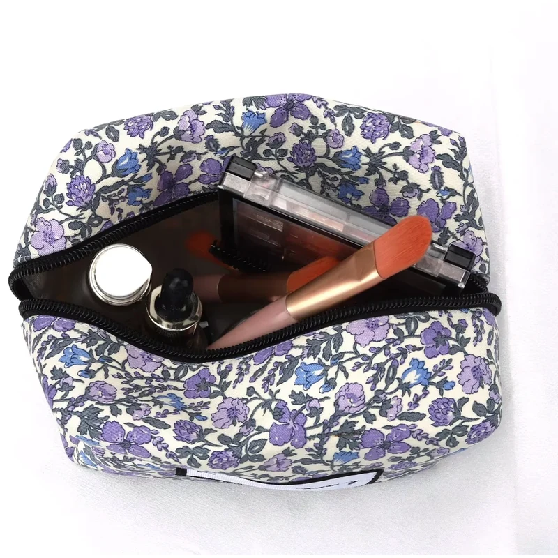 An open floral zipper bag showing cosmetics inside.